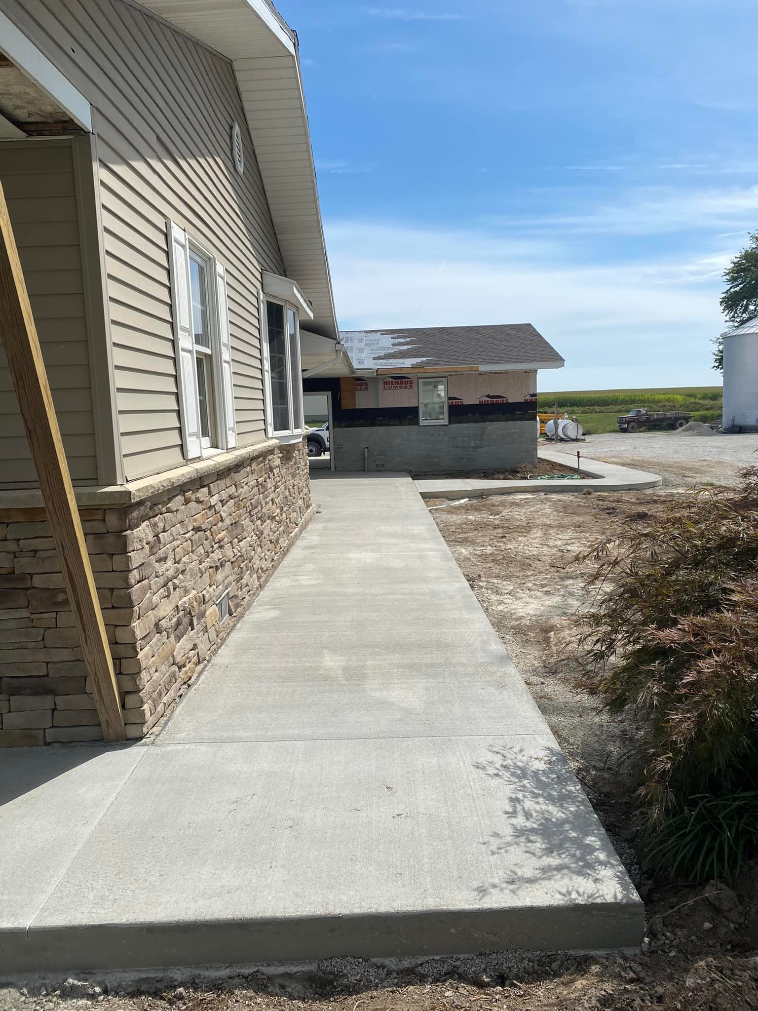 Concrete sidewalk along house